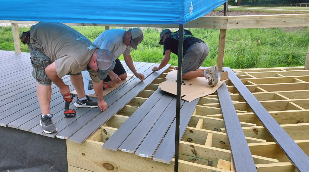 Local volunteers from the International Union of Elevator Constructors rebuild a fishing pier at the Texas Freshwater Fisheries Center.